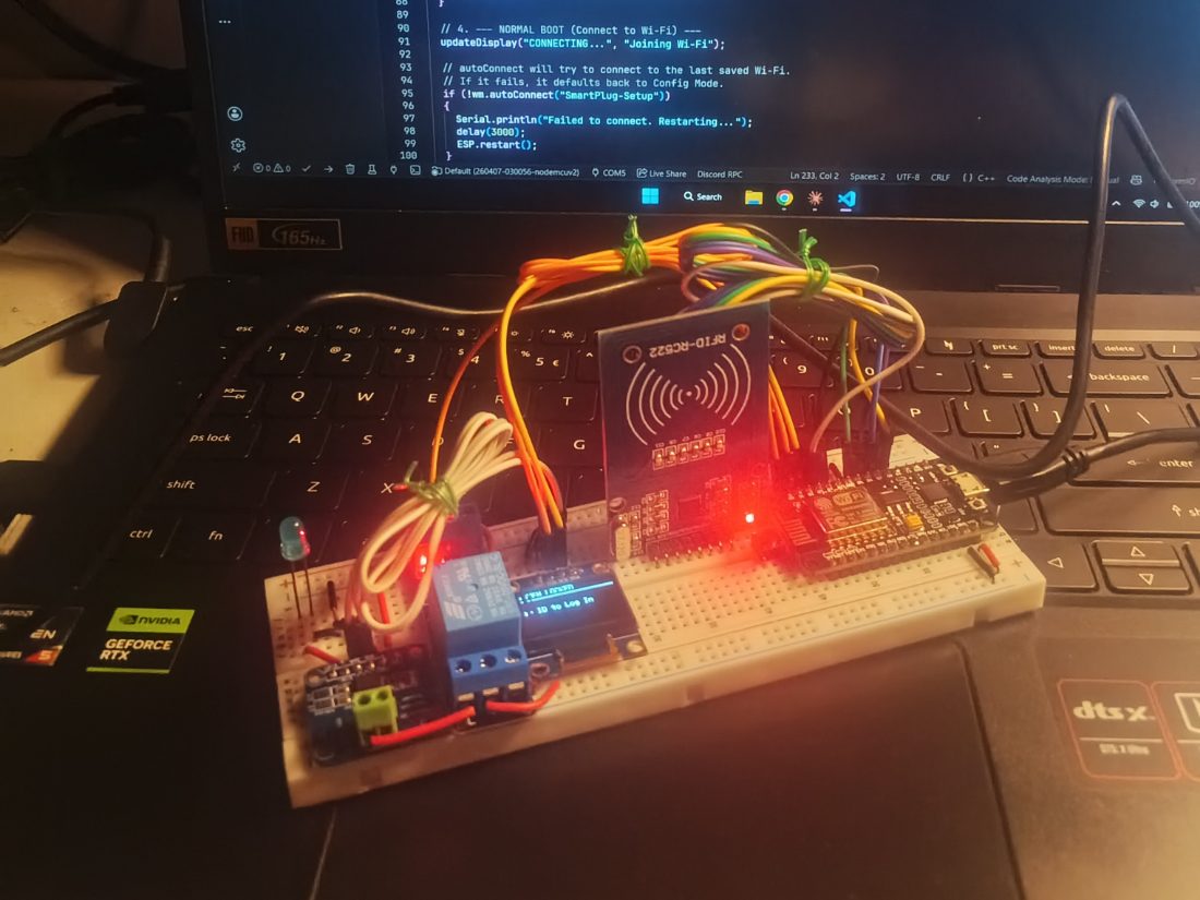 Breadboard prototype of the smart plug: an RFID-RC522 reader, a NodeMCU ESP8266, a relay module and a small OLED prompting for a badge.