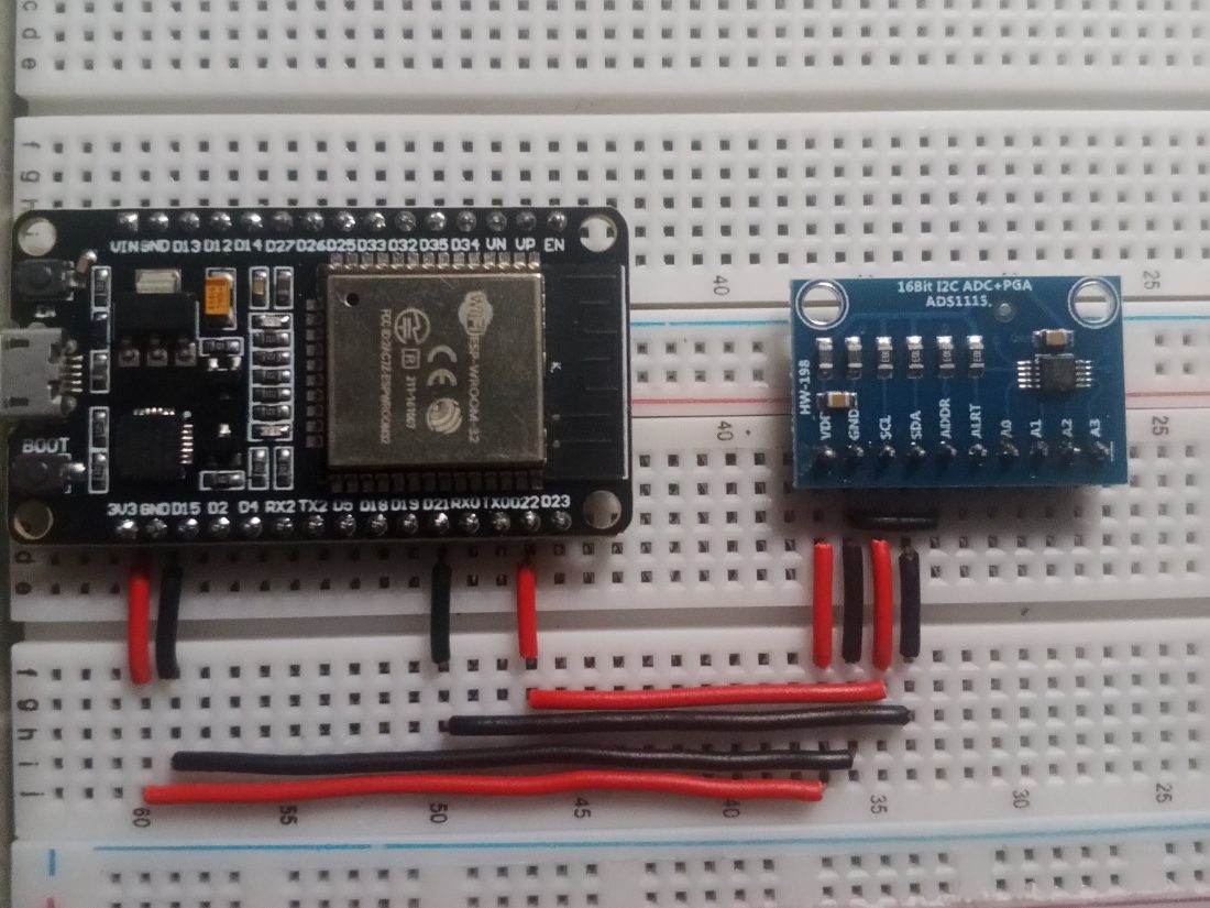 An ESP32-WROOM-32 board and an ADS1115 analogue-to-digital converter on a breadboard with jumper wires.
